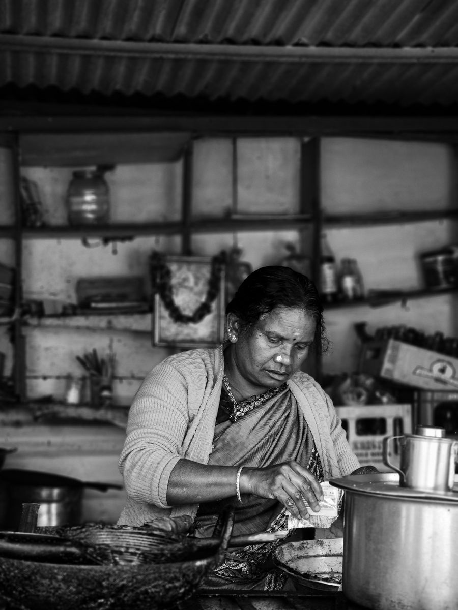 A home cook preparing food in a South Indian kitchen